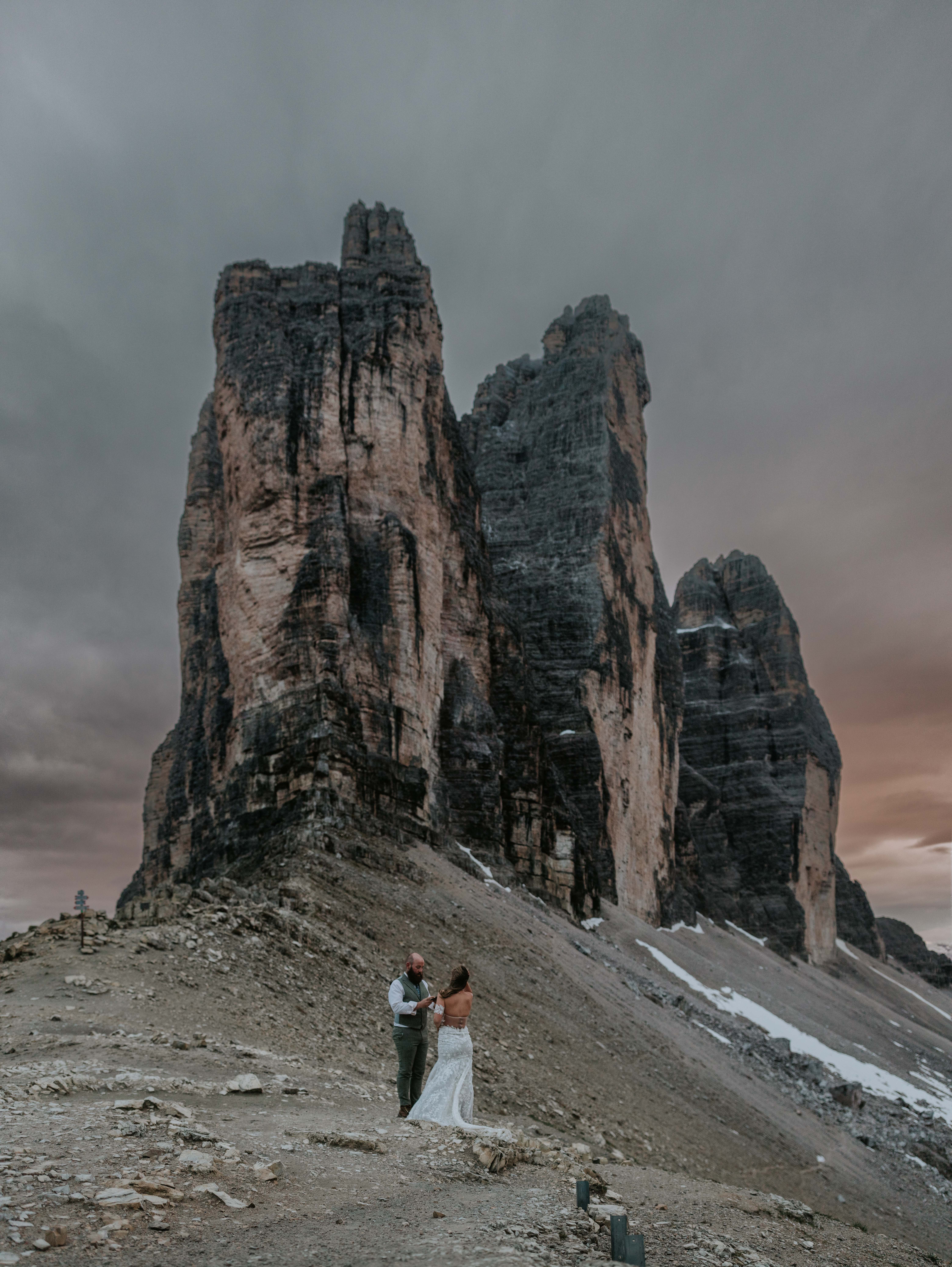 A couple reads their wedding vows under the Tre Cime de Lavaredo peaks during their sunset elopement