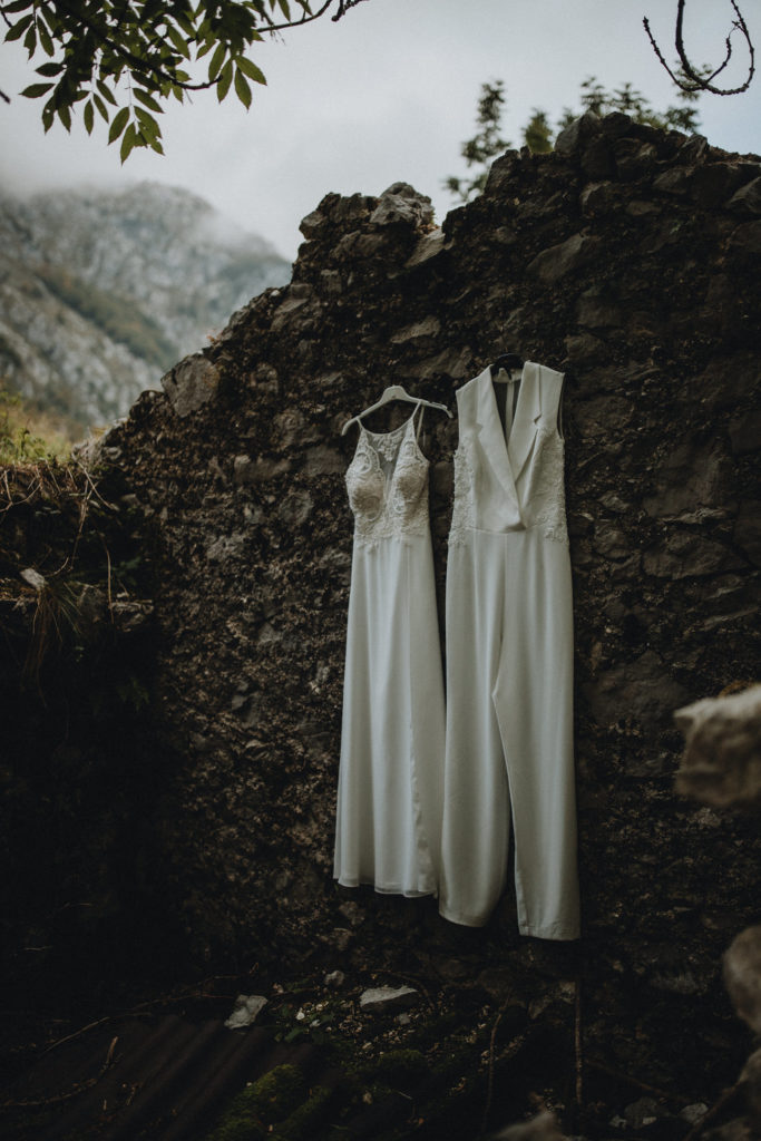 Slovenia elopement photography details outfits hanging from stone hut.