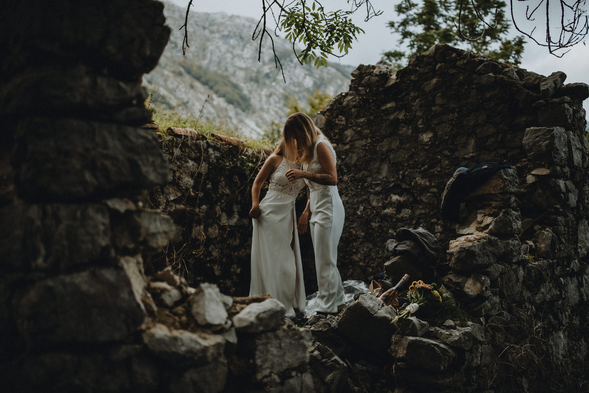 Two women get ready for their elopement in the Slovenian Alps in an abandoned stone hut