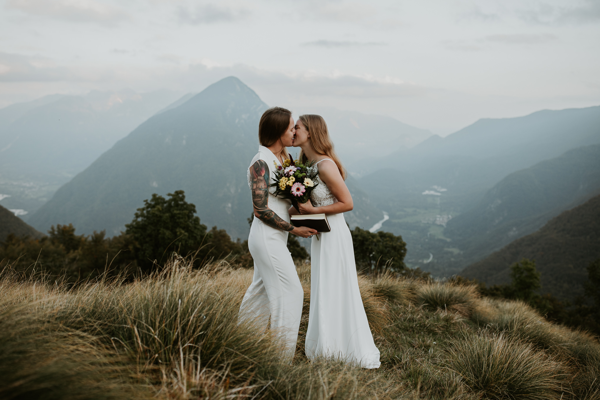 A couple kiss after their vow ceremony during their Slovenian Alps mountain elopement.