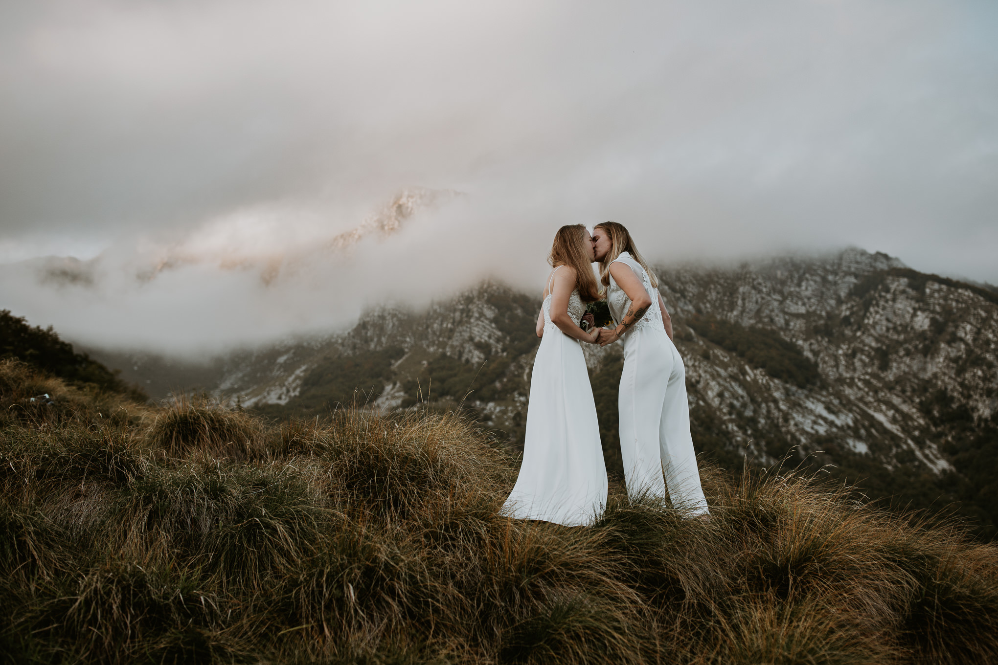 Couple kiss during their mountain elopement in the Slovenian Alps