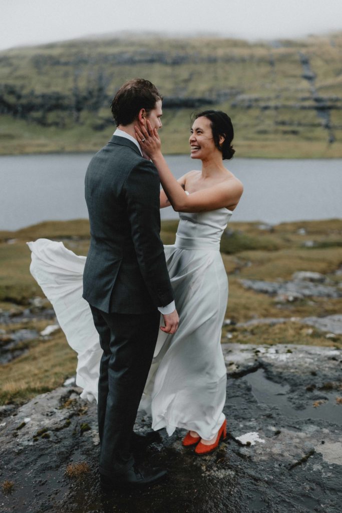 The image is a couple holding each other during their Faroe Islands elopement photography session.