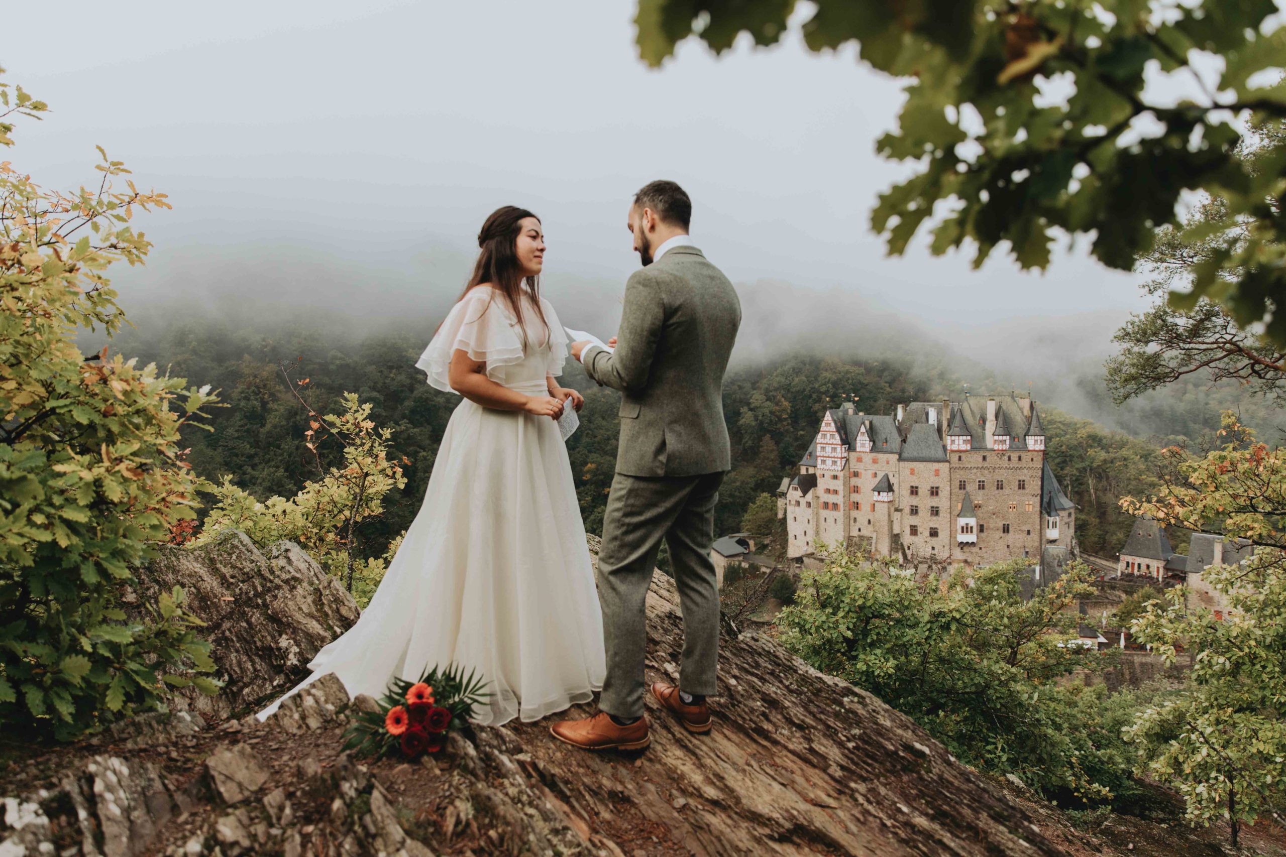 Couple reads emotional vows during their elopement outside Burg Eltz in Germany