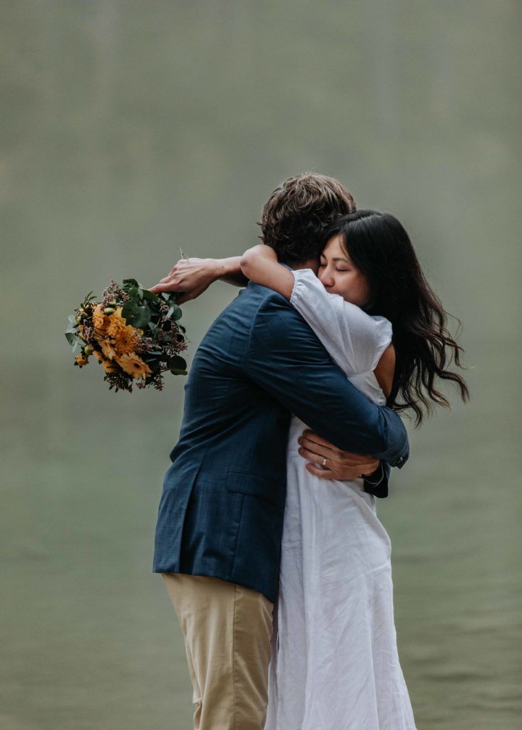 Couple hugs near the Hintersee during their October elopement in Berchtesgaden, Germany
