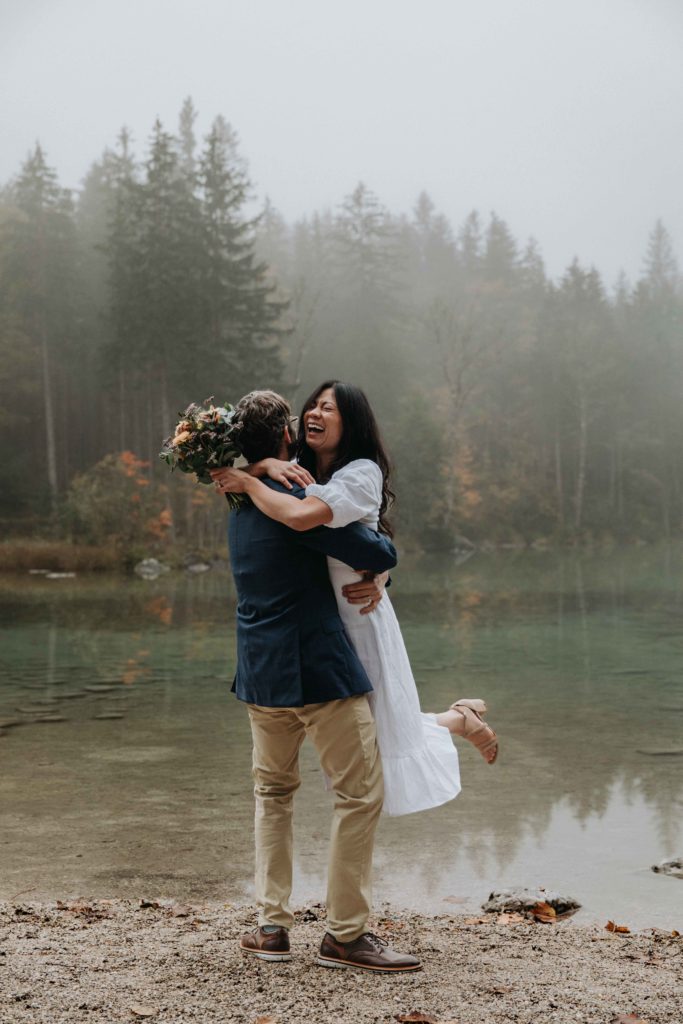 Couple dances and laughes near the Hintersee during their October elopement in Berchtesgaden, Germany