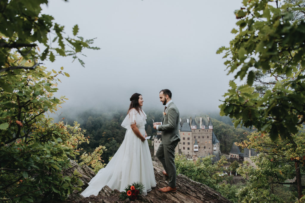 Couple reads vows for their elopement outside Burg Eltz in Germany