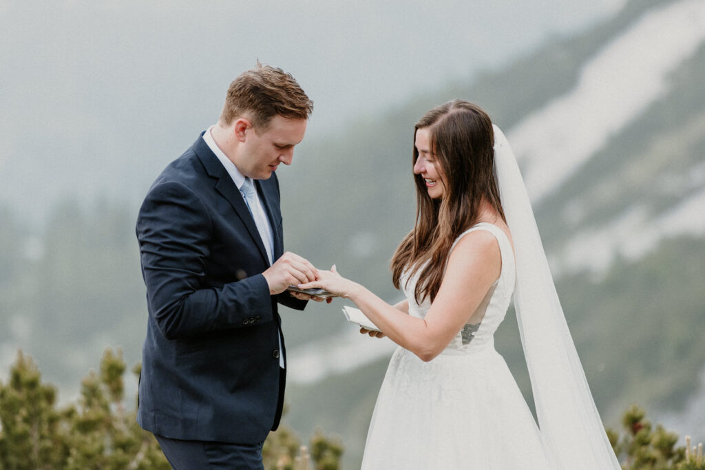 A couple exchange rings on their elopement day under the Austrian Zugspitze