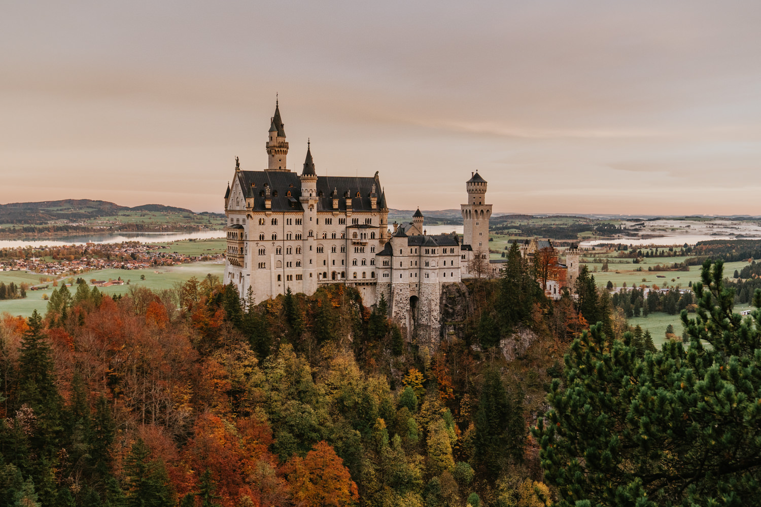 Castle Neuschwanstein in Germany during a warm October sunrise