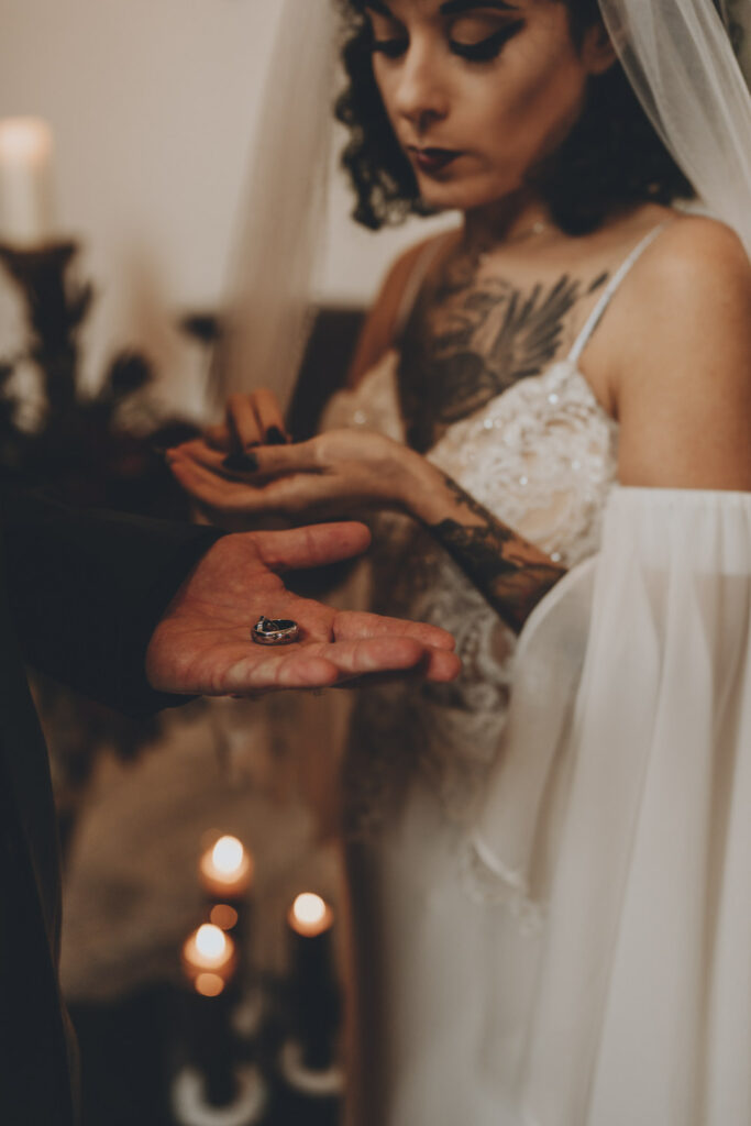 A couple exchange rings during their gothic wedding ceremony at a medieval castle in Austria