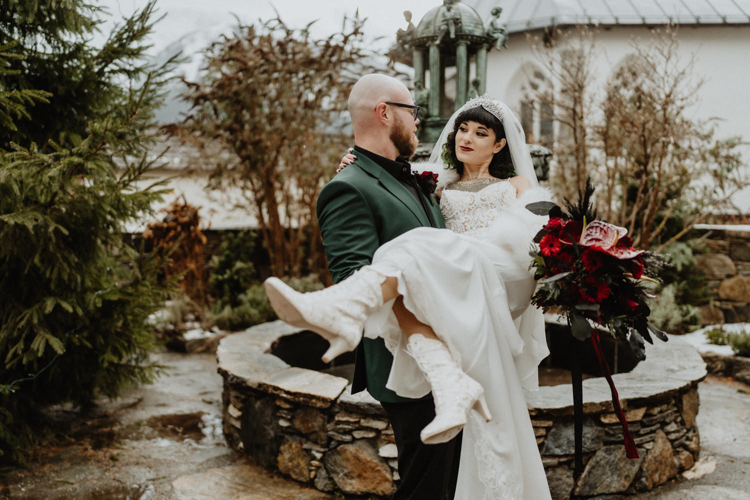 A man holds his bride during their Austria elopement at a gothic castle