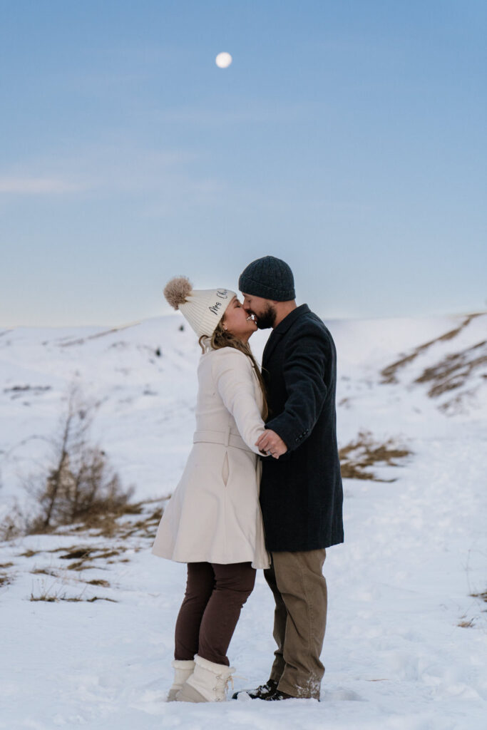 Panoramic winter summit proposal with snow capped Dolomites at sunrise with full moon