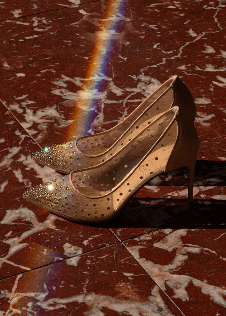A pair of sparkling Louboutins sits in the sun at the Grand Hotel Tremezzo in Lake Como, on a couple's elopement day