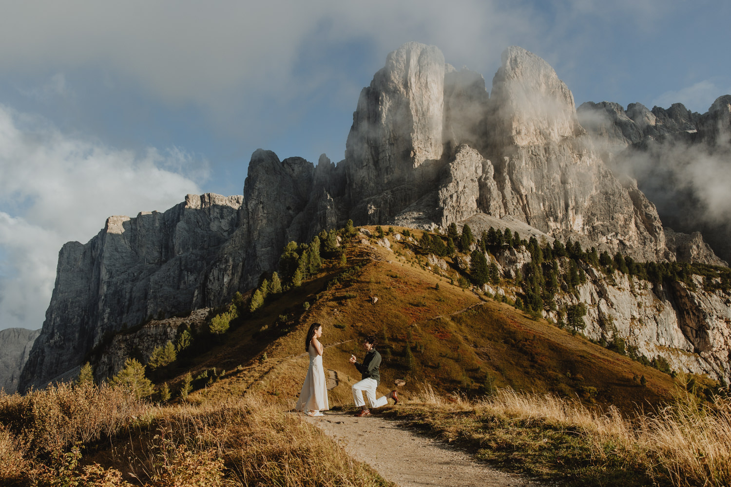 A man proposes to his partner at a Dolomites mountain pass during golden hour